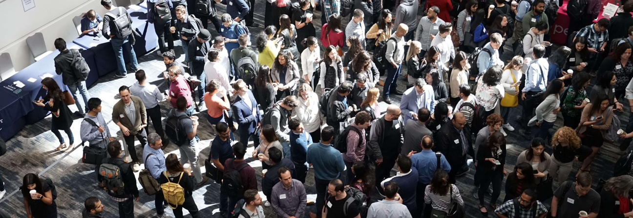 A large group of people standing in a room.