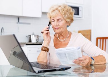 A woman holding a pen and a paper.