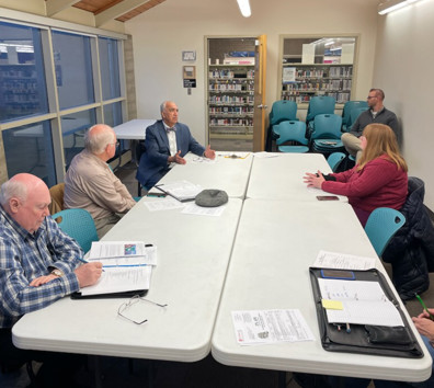A group of people sitting around a table.