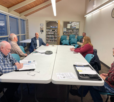 A group of people sitting around a table.