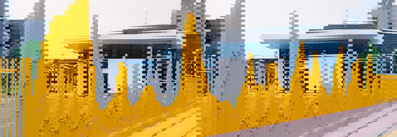 A building with a yellow fence.