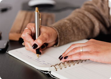 A person writing on a piece of paper.