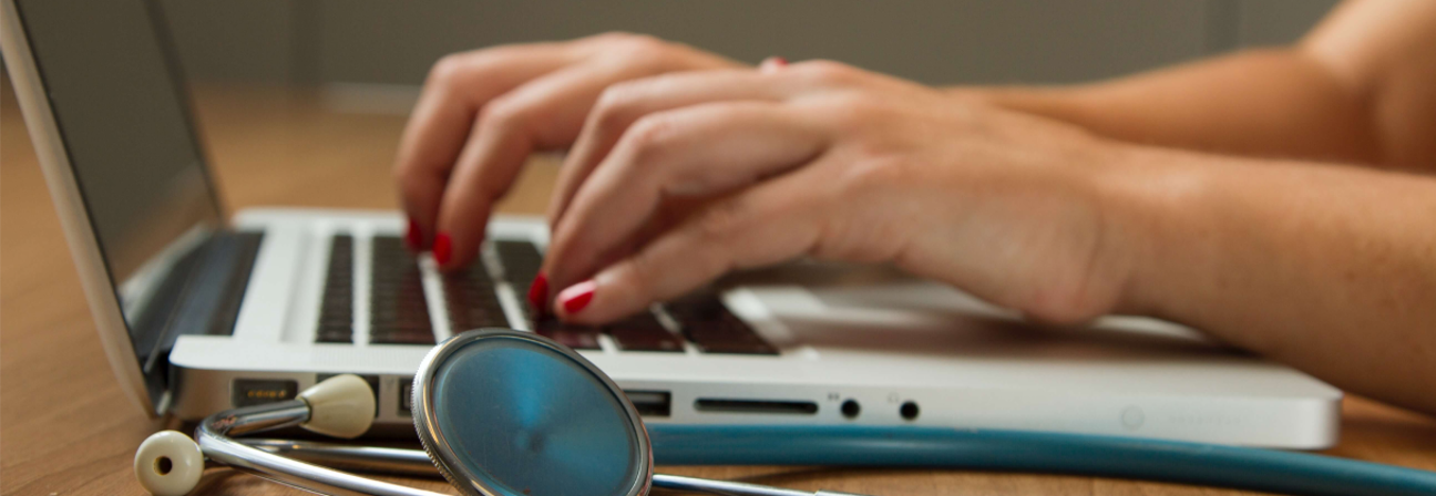 A person typing on a laptop.