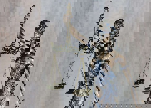 A statue of a person holding a staff.