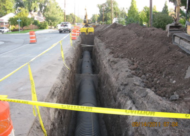 A road with a pile of dirt and a pile of dirt.